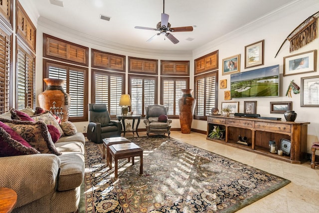 tiled living room with ceiling fan, plenty of natural light, and crown molding