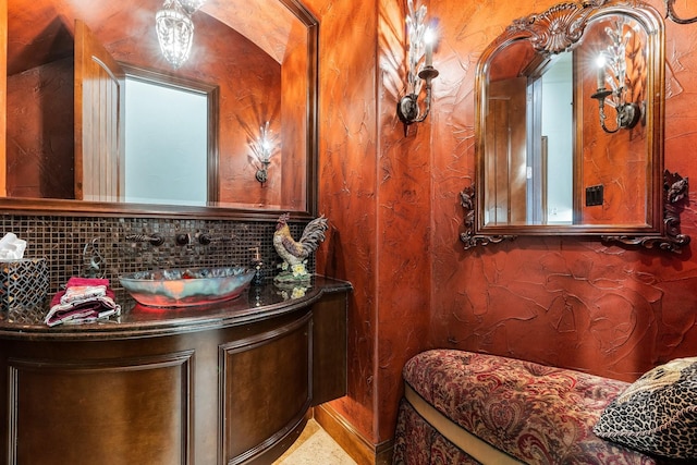 bathroom featuring tasteful backsplash and vanity