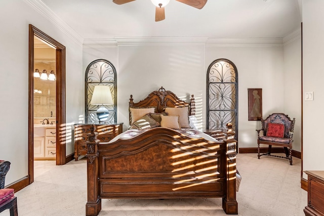 bedroom featuring ceiling fan, crown molding, sink, and ensuite bath