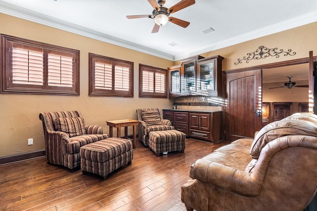 sitting room featuring ceiling fan, dark hardwood / wood-style flooring, and crown molding