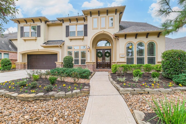 view of front of home featuring a garage and french doors