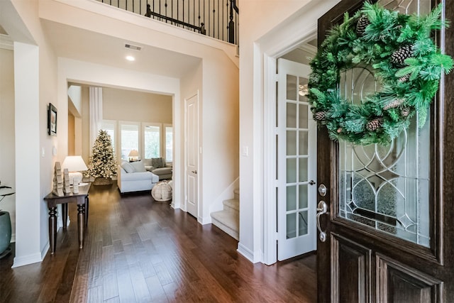 entryway with dark hardwood / wood-style flooring