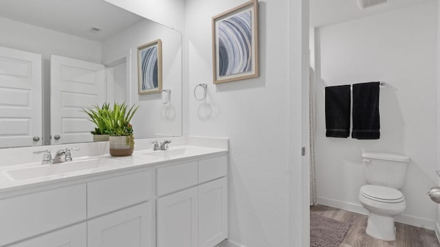 bathroom featuring hardwood / wood-style floors, vanity, and toilet