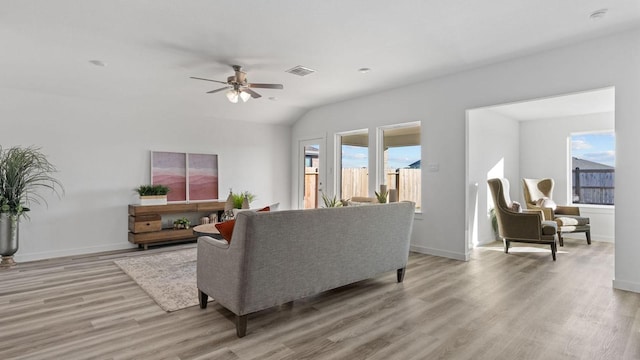 living room featuring ceiling fan and light hardwood / wood-style floors