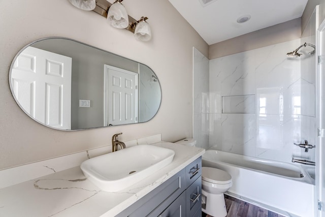 full bathroom featuring wood-type flooring, vanity, toilet, and shower / bathtub combination