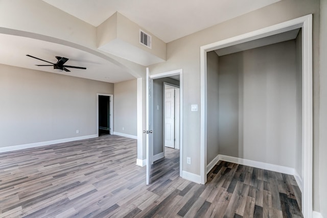 unfurnished bedroom featuring hardwood / wood-style flooring, ceiling fan, and a closet