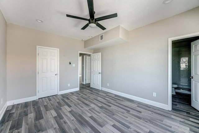 unfurnished bedroom featuring connected bathroom, ceiling fan, and hardwood / wood-style flooring