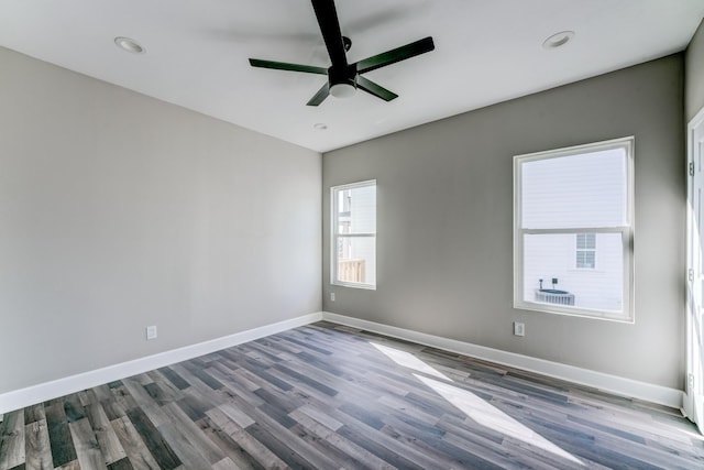 spare room with hardwood / wood-style floors and ceiling fan