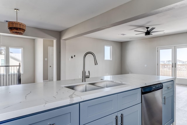 kitchen featuring dishwasher, sink, ceiling fan, plenty of natural light, and light stone counters