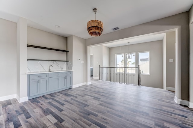 unfurnished living room with sink and light wood-type flooring