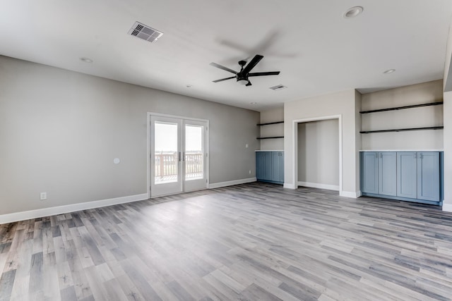 unfurnished living room with ceiling fan, french doors, and light hardwood / wood-style floors