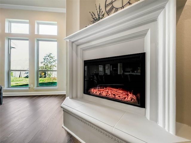 interior details with hardwood / wood-style flooring and crown molding