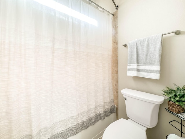 bathroom with shower / tub combo and toilet