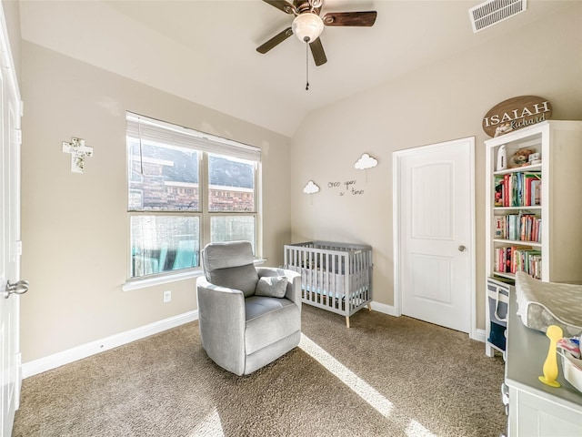 bedroom featuring a crib, carpet floors, ceiling fan, and lofted ceiling