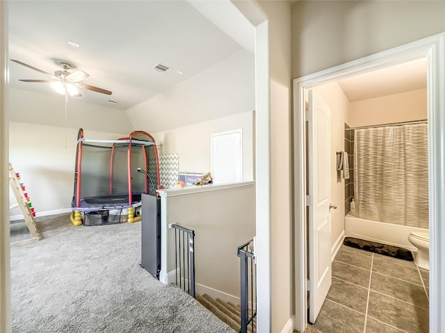 hall featuring carpet floors and lofted ceiling