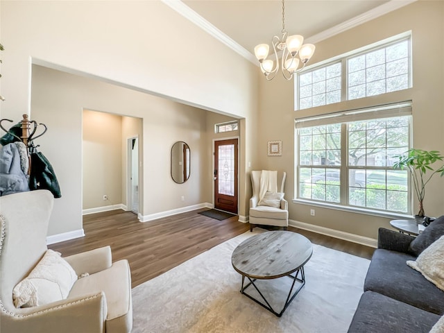 living room featuring crown molding, dark wood-type flooring, and a chandelier