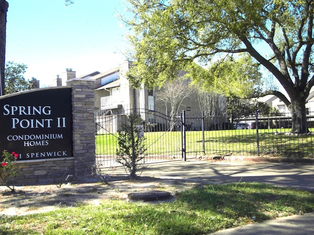 community / neighborhood sign with a lawn