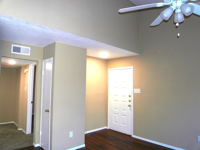 interior space featuring ceiling fan and dark hardwood / wood-style floors