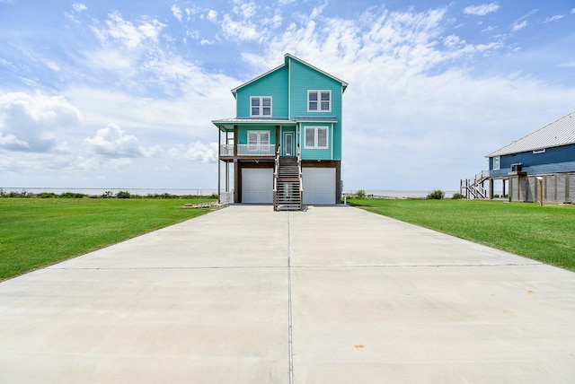 view of front of property featuring a garage and a front yard