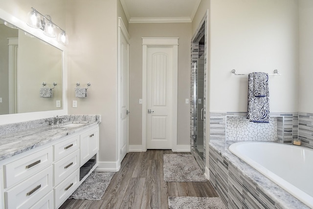 bathroom featuring hardwood / wood-style flooring, vanity, separate shower and tub, and crown molding