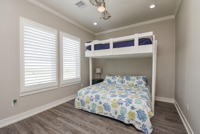 bedroom with ceiling fan, dark hardwood / wood-style flooring, and ornamental molding