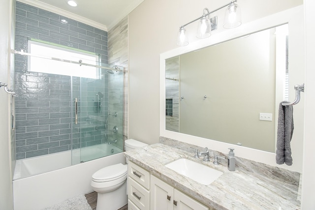 full bathroom with shower / bath combination with glass door, vanity, ornamental molding, and toilet