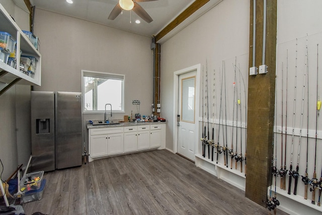 kitchen featuring dark hardwood / wood-style flooring, ceiling fan, sink, stainless steel fridge with ice dispenser, and white cabinetry