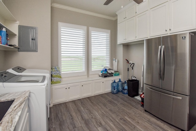 laundry area with cabinets, electric panel, washing machine and dryer, ornamental molding, and dark hardwood / wood-style flooring