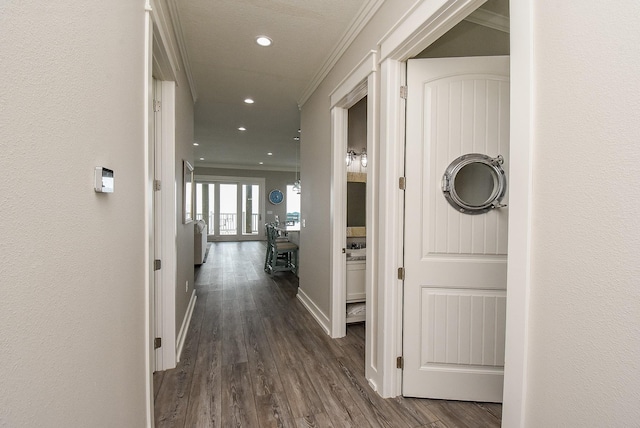 hallway with dark hardwood / wood-style floors and ornamental molding