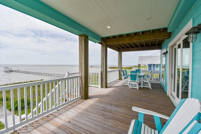 wooden terrace featuring a water view