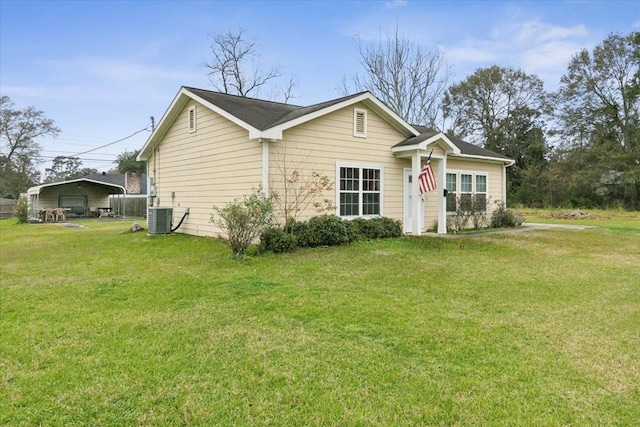 view of front of property with central AC and a front lawn