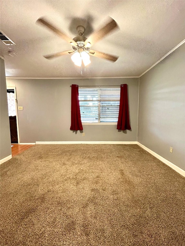 carpeted spare room featuring a textured ceiling, ceiling fan, and crown molding