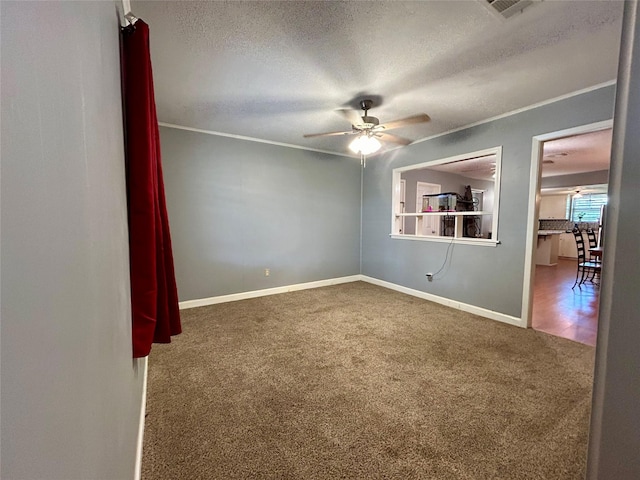 empty room with ceiling fan, carpet floors, and a textured ceiling