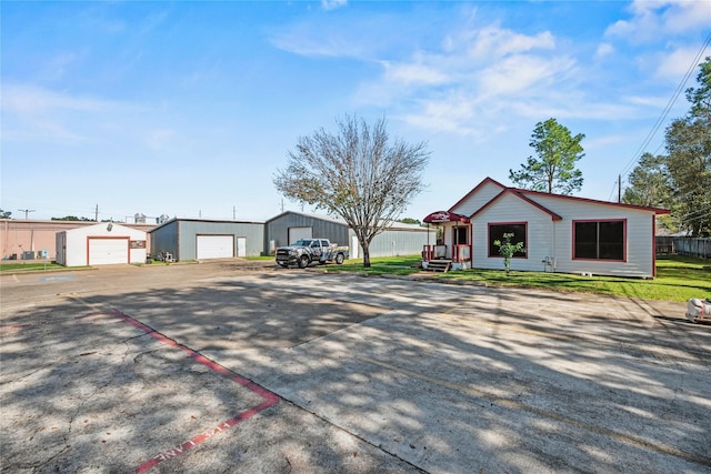 ranch-style home featuring a garage and an outbuilding