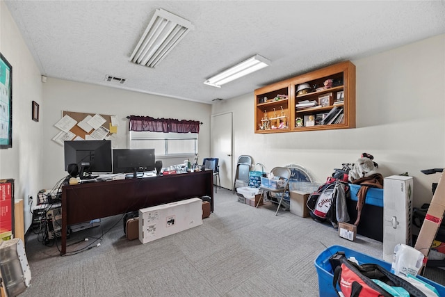 carpeted home office with a textured ceiling