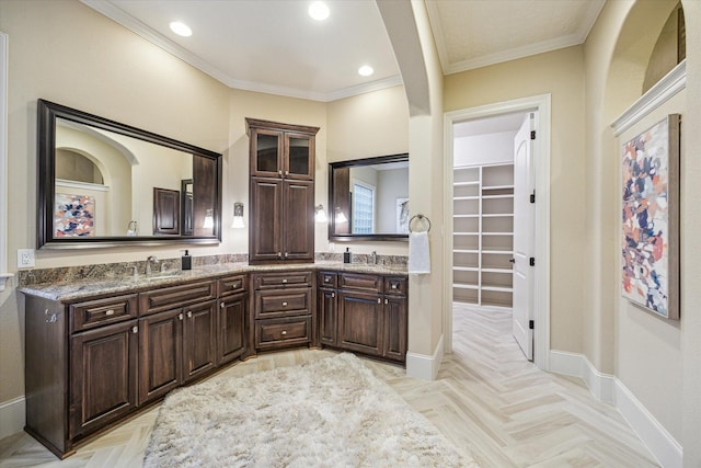 bathroom featuring parquet flooring, vanity, and crown molding