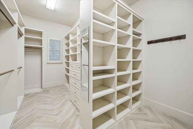 spacious closet with light parquet floors