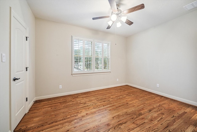 spare room featuring hardwood / wood-style floors and ceiling fan