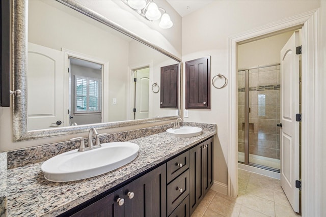 bathroom with tile patterned flooring, vanity, and an enclosed shower