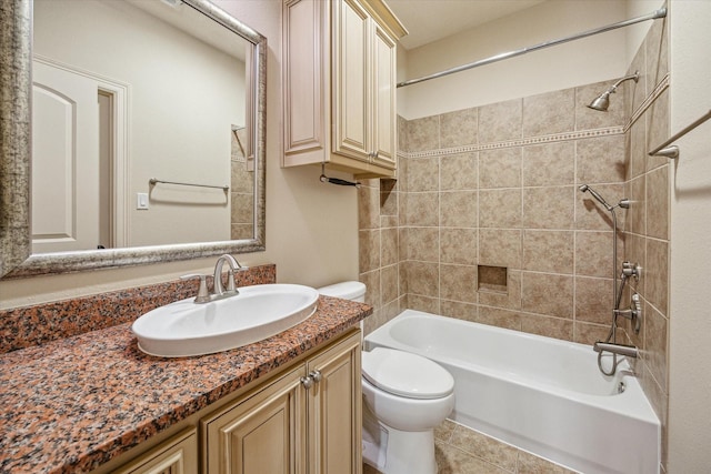 full bathroom featuring toilet, vanity, and tiled shower / bath