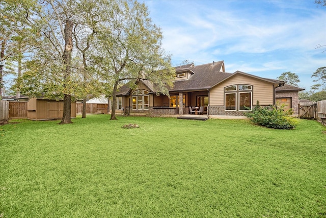 rear view of property with a patio, a shed, and a lawn