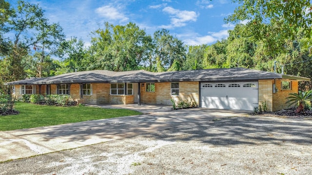 single story home with a front yard and a garage