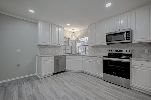 kitchen featuring sink, appliances with stainless steel finishes, white cabinetry, decorative backsplash, and light wood-type flooring