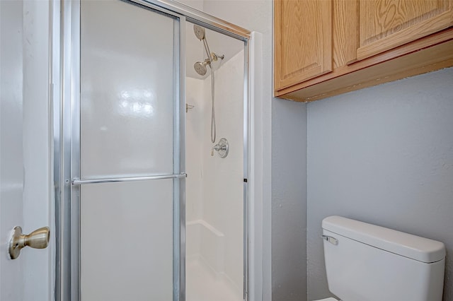 bathroom with walk in shower and toilet