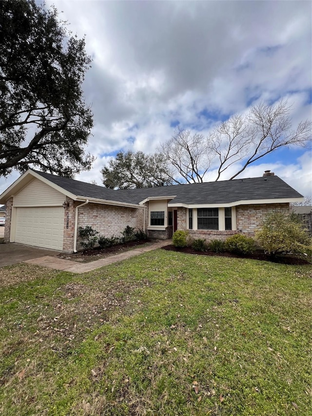 ranch-style house with a garage and a front lawn