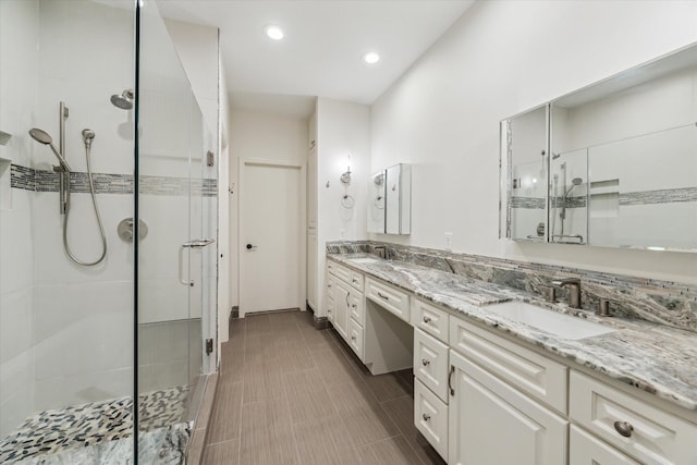 bathroom with vanity and a shower with shower door