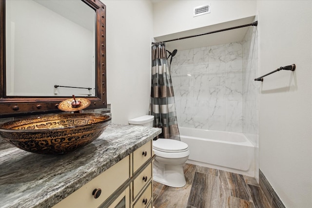 full bathroom featuring vanity, shower / bath combination with curtain, and toilet