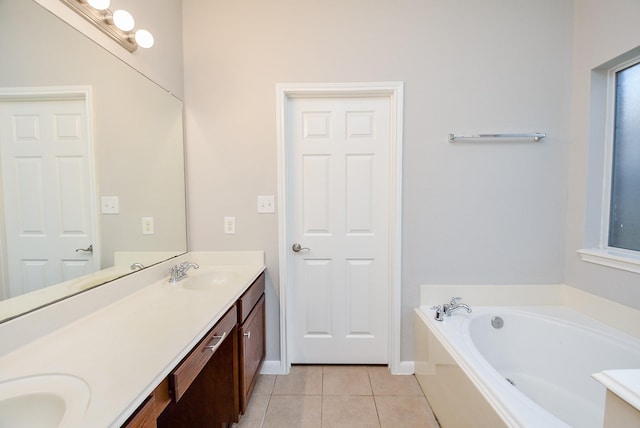 bathroom featuring tile patterned floors, vanity, and a bathing tub