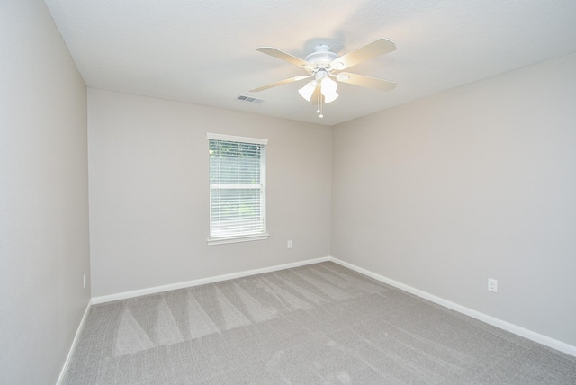 unfurnished room featuring light carpet and ceiling fan