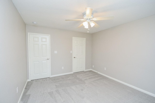 carpeted empty room featuring ceiling fan